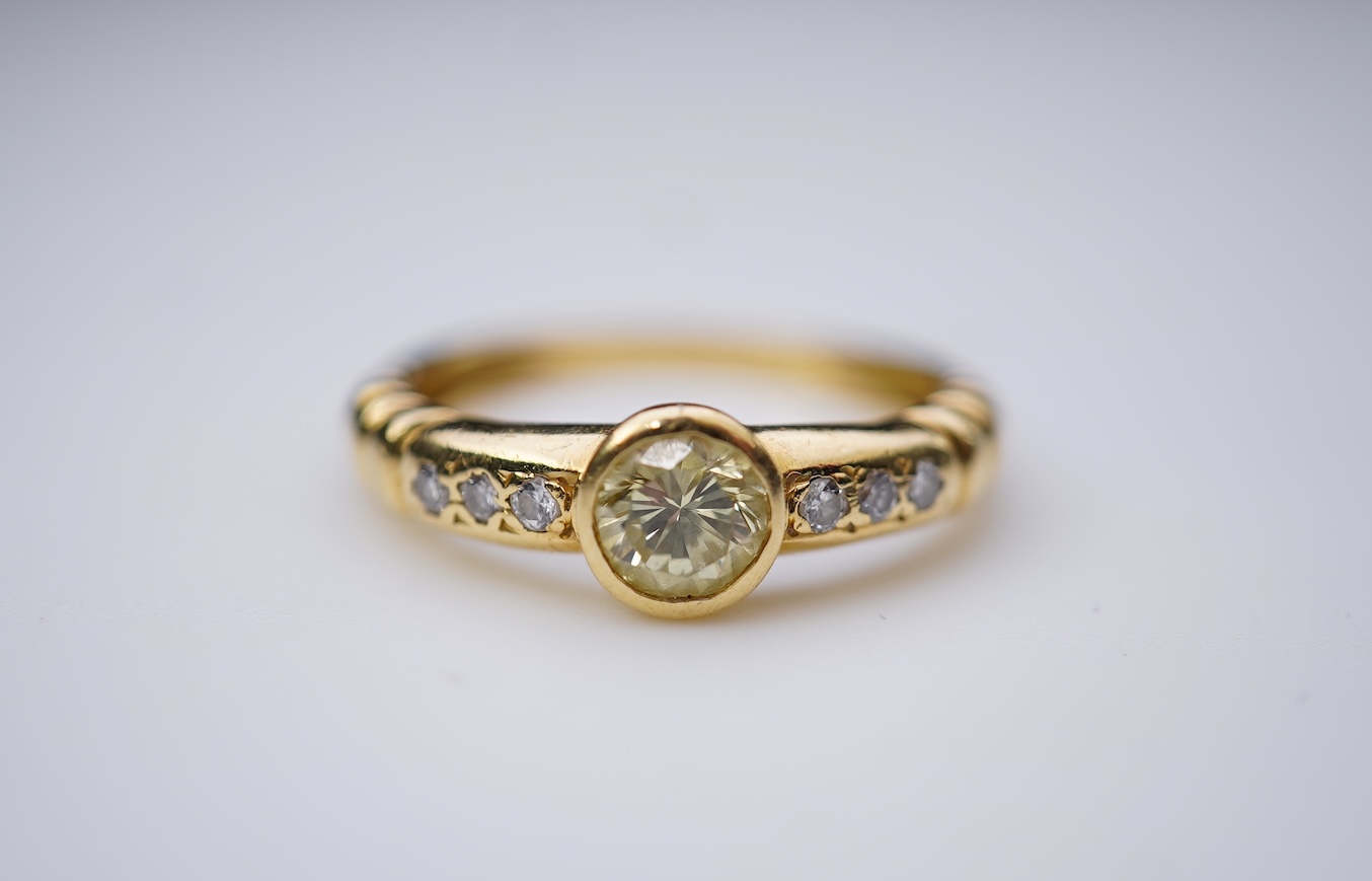 A yellow diamond and diamond ring